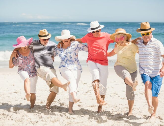Group-of-senior-friends-dancing-on-the-beach